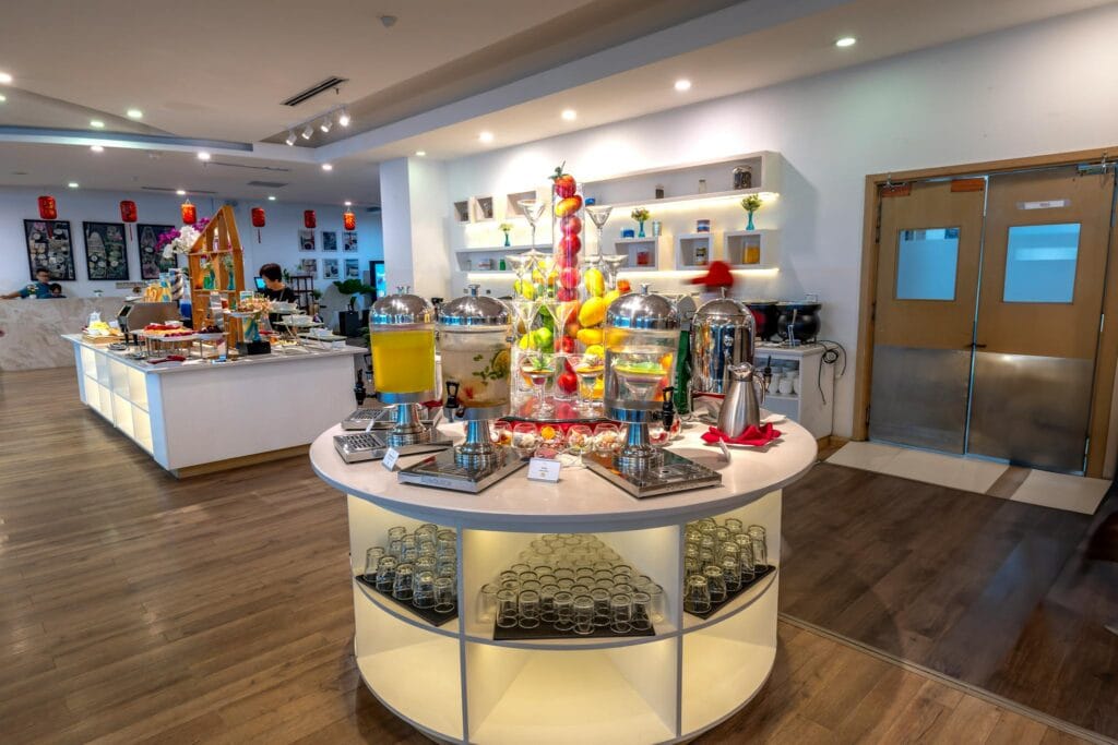 Luxurious buffet display with diverse food and beverages in a modern hotel setting.